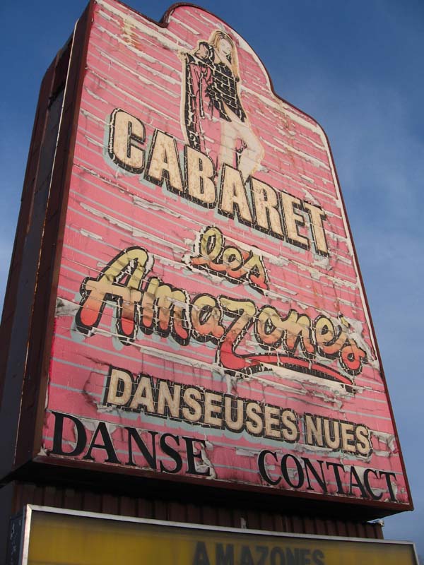 East-bound traffic is solicited with this sad, sun-washed and weather-beaten sign.