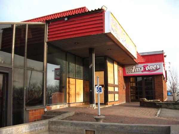 Picasso’s boarded-up west-side entry and the door to the debauchery below.